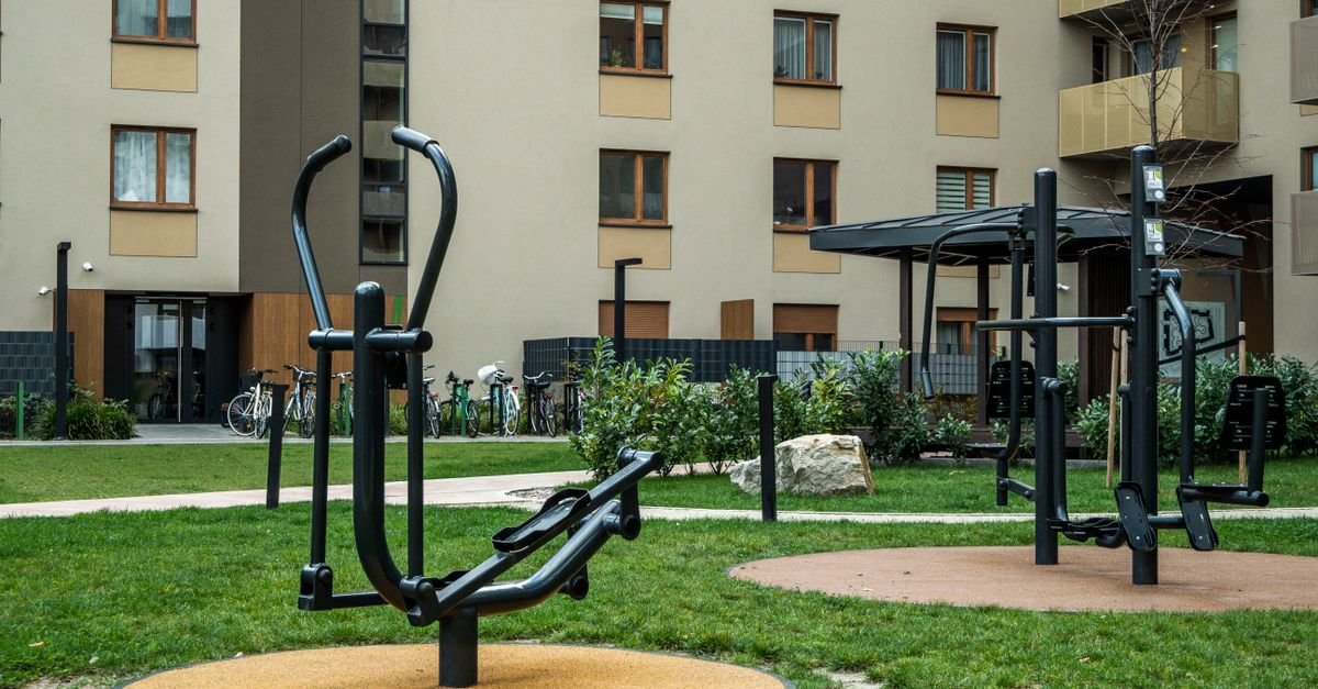 Modern outdoor gym equipment in a residential courtyard, promoting fitness and healthy lifestyle.