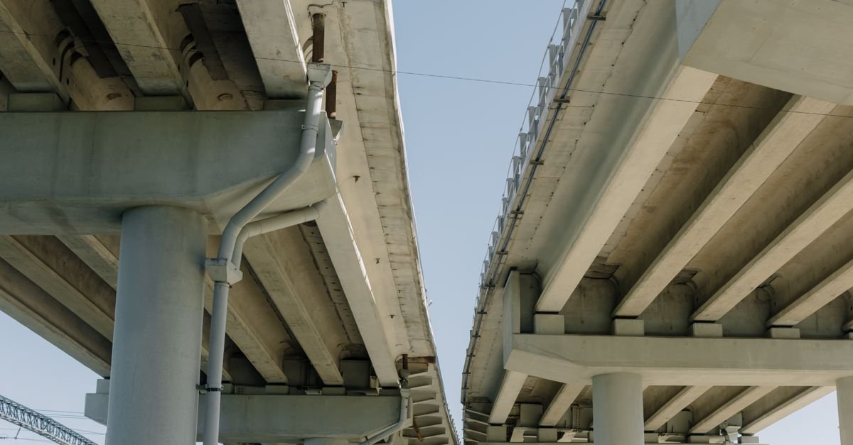 Concrete roadway overpass and pillars with clear blue sky background