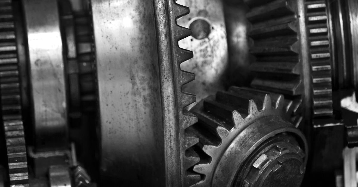Detailed black and white photo showing close-up of metal gears in an engine, showcasing industrial technology.