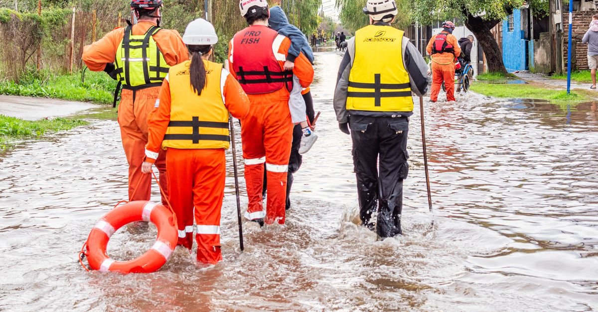 Rescue team evacuates flood victims in Buenos Aires. Humanitarian aid at work.