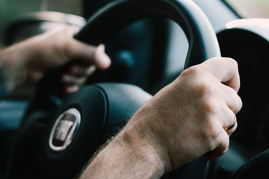 Mãos firmes segurando volante de veículo durante condução
