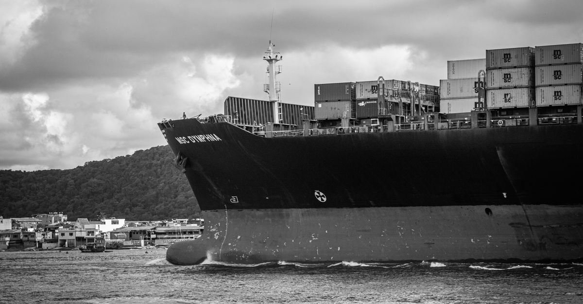 Grayscale image of a large container ship in the Port of Santos, Brazil.