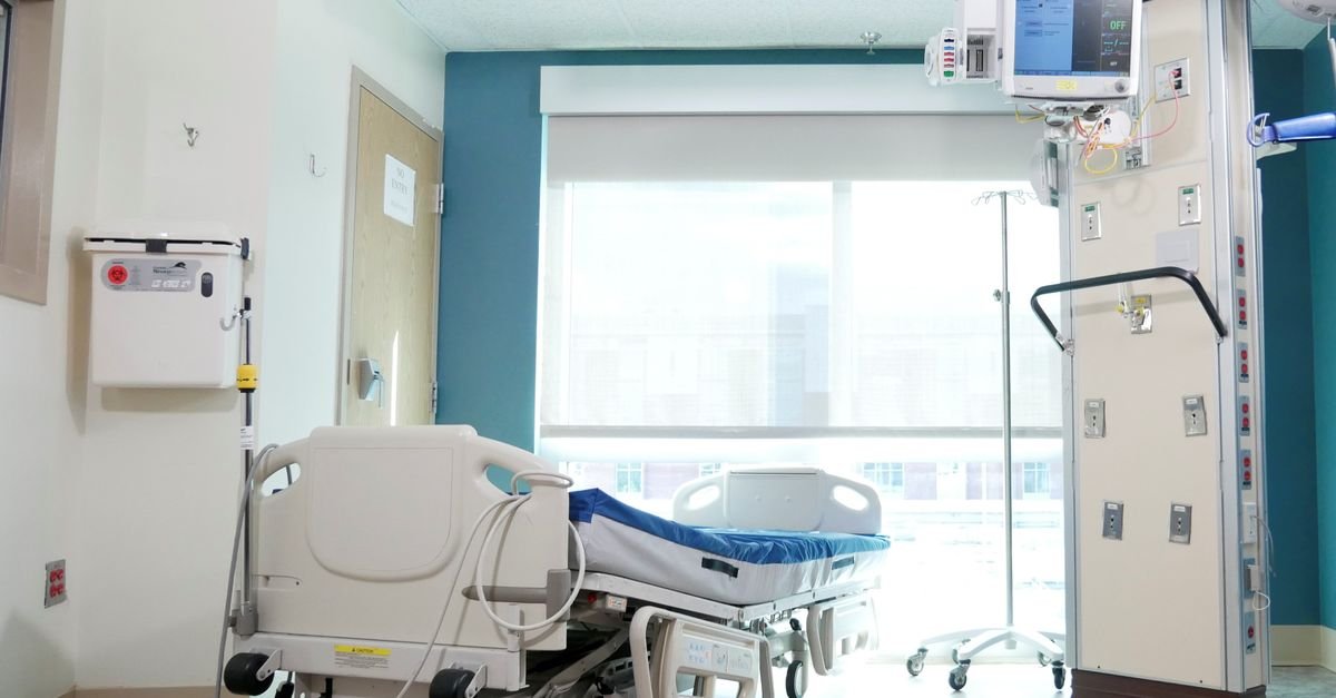 A well-equipped hospital room with a bed and advanced medical equipment.