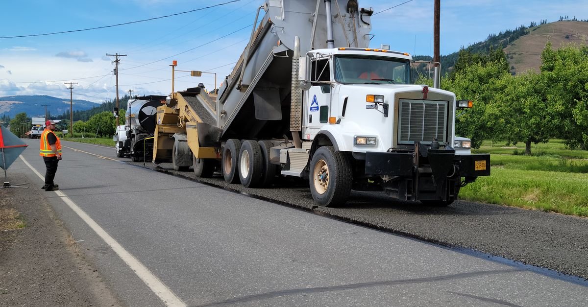 Paving equipment and crew working on road construction in Hood River, Oregon.