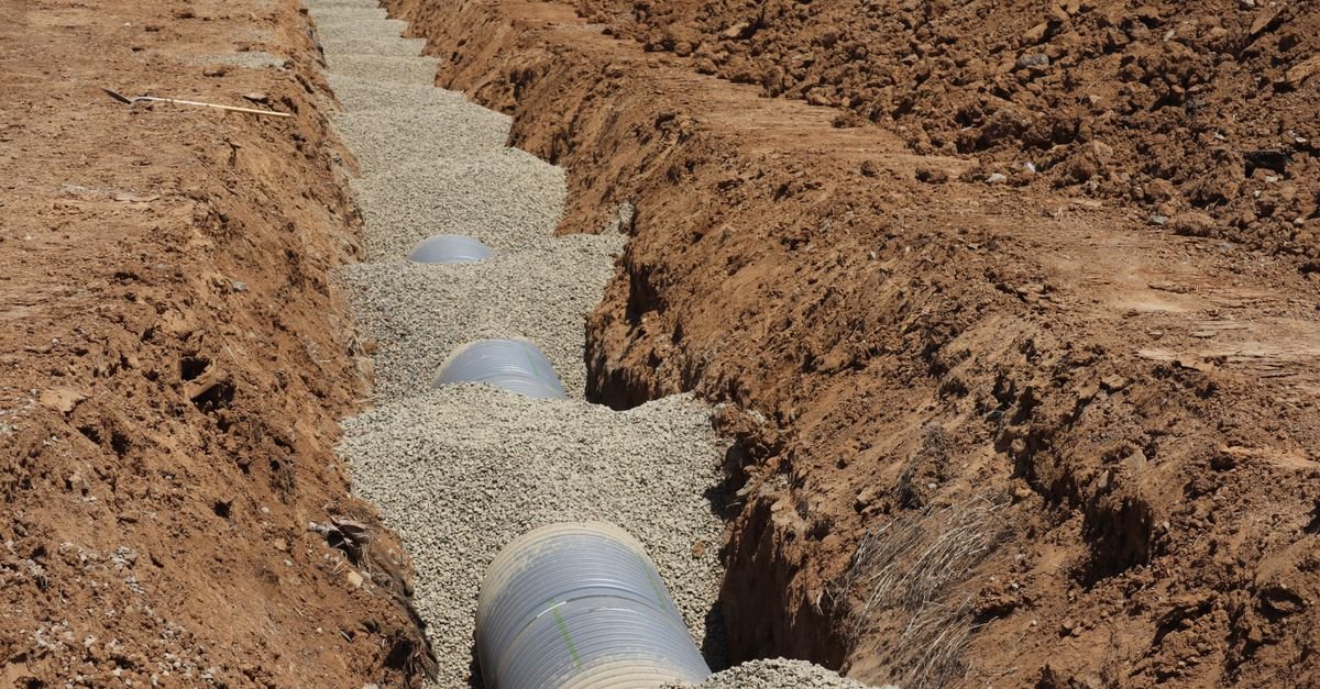 Detailed view of drainage pipe construction in a trench, Elk Grove, California.