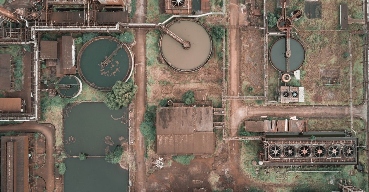 Amazing drone view of huge area of modern wastewater treatment plant with tanks of dirty and clean water