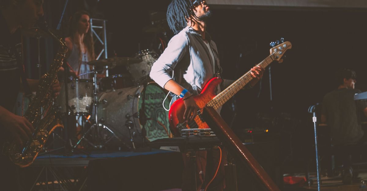 Dynamic live band performance featuring instruments and musicians on stage.