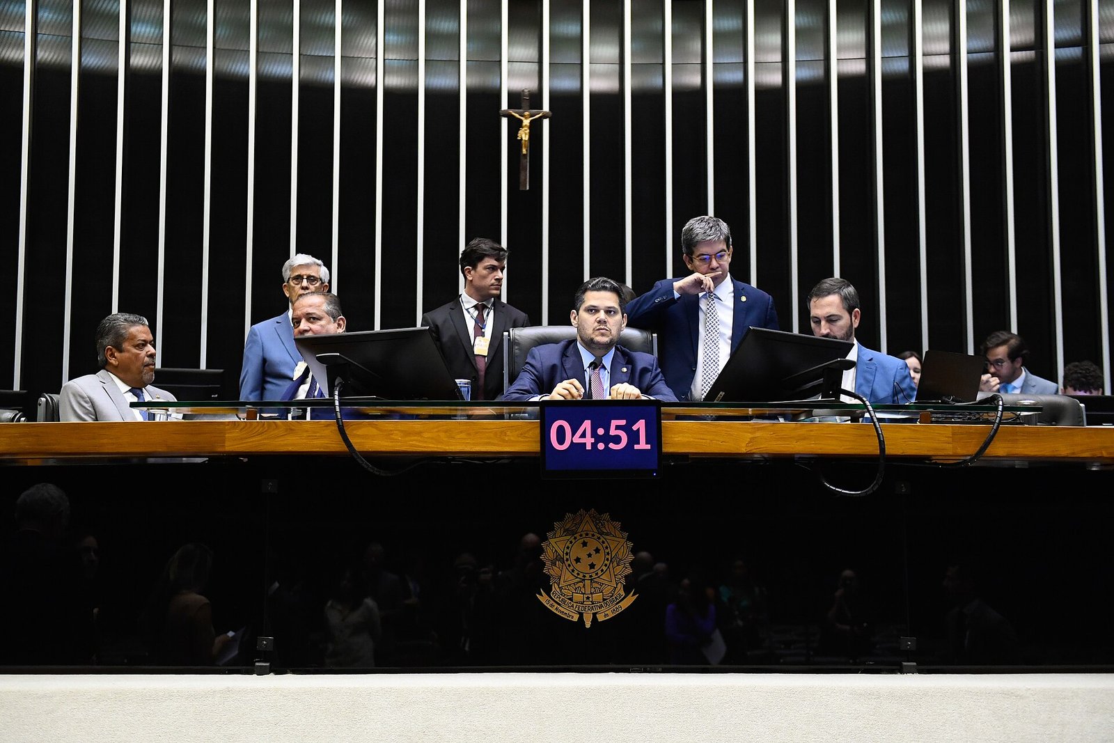 Mesa do Congresso Nacional durante sessão conjunta no plenário da Câmara dos Deputados, com o brasão da República ao centro
